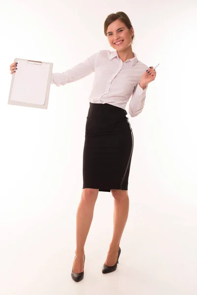 Girl in a skirt and blouse stands with a tablet. — Stock Photo, Image