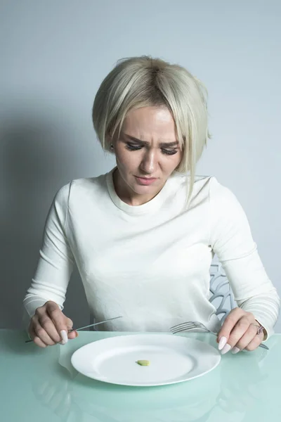 Sick girl with anorexia sits before eating. — Stock Photo, Image