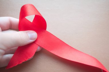 AIDS farkındalık kurdelesi, kırmızı kurdele, HIV farkındalığı konsepti, dünya AIDS günü. Dünya AIDS Yetimleri Günü. Farkındalık Ayı