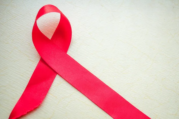AIDS farkındalık kurdelesi, kırmızı kurdele, HIV farkındalığı konsepti, dünya AIDS günü. Dünya AIDS Yetimleri Günü. Farkındalık Ayı