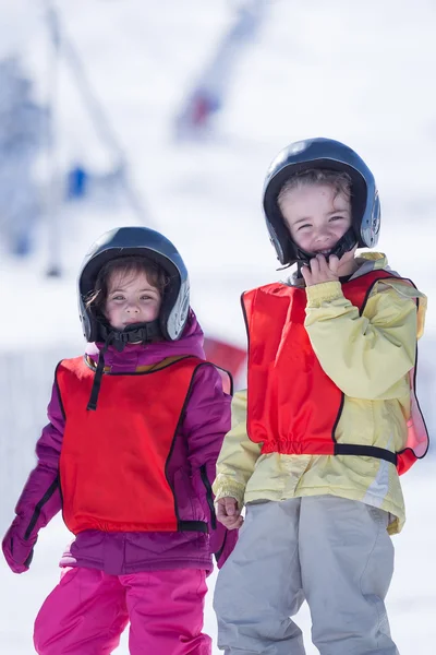 Boy and girl in helmet on ice hill — Stock Photo, Image