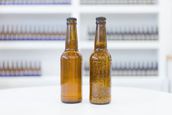 Beer bottles on white table — Stock Photo, Image