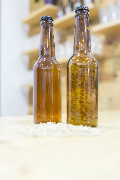 Beer bottles with some groats — Stock Photo, Image
