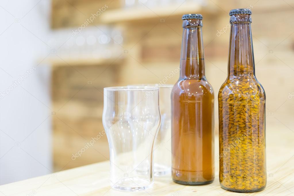 Beer glasses and bottles on wooden shelf