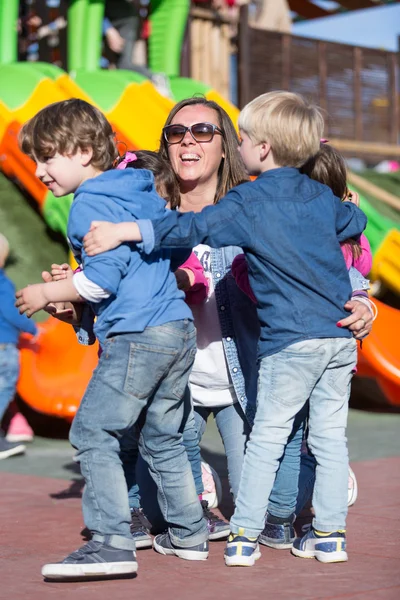 Niños abrazando a su madre —  Fotos de Stock