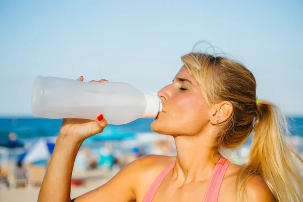 Blonde sportswoman drinking water Stock Photo
