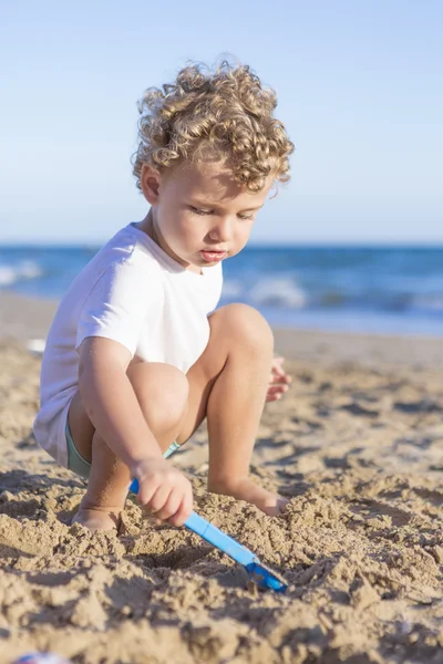 Criança brincando com a areia — Fotografia de Stock