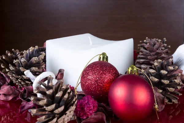 Christmas composition - balls and white candle — Stock Photo, Image