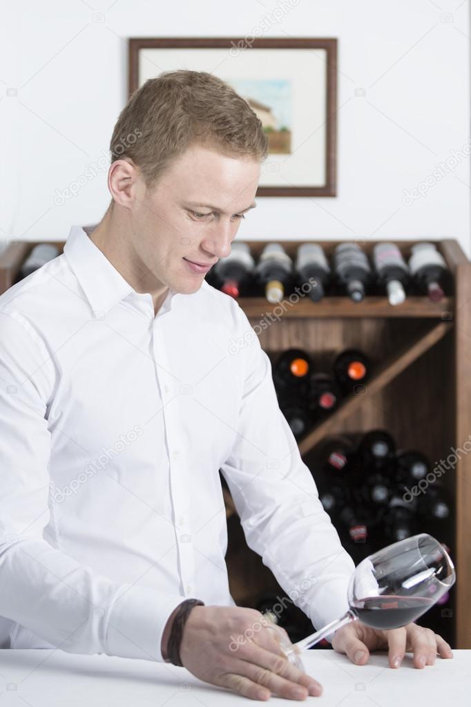 man examining a wine glas