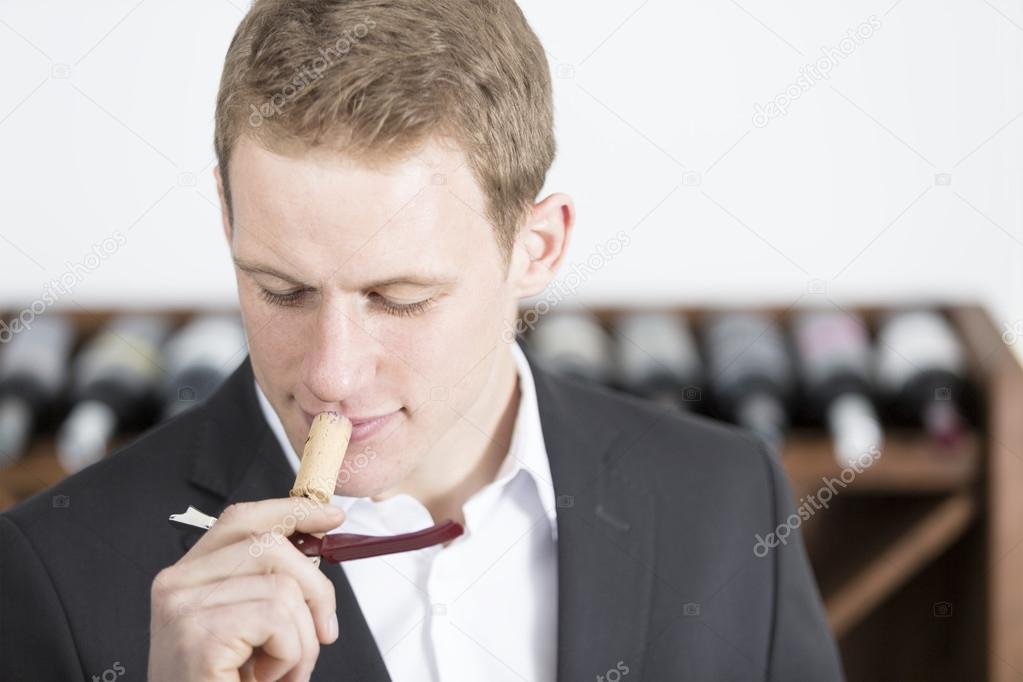man smelling a cork stoppe