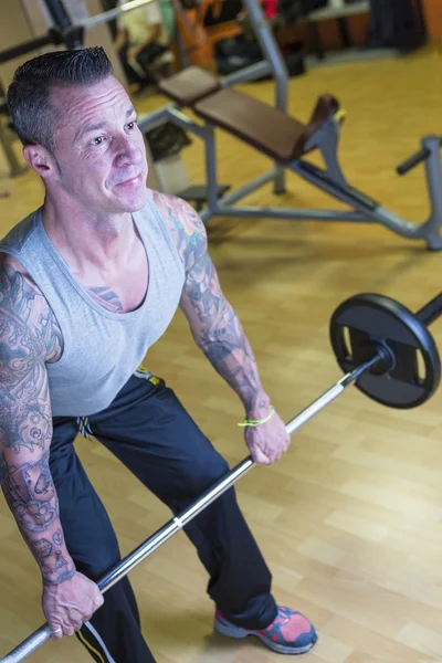 Man making barbell row - workout routine — Stock Photo, Image