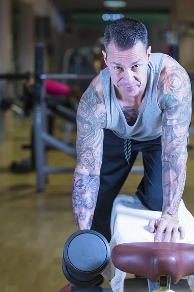 Man making dumbbell row - workout routine — Stock Photo, Image