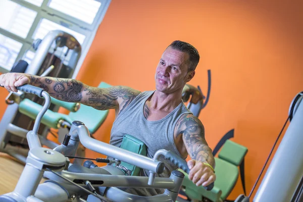 Man making seated rowing - workout routine — Stock Photo, Image