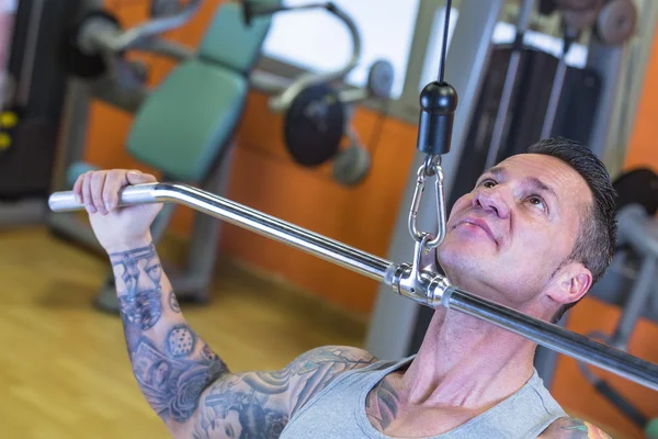 Young man making pull downs - workout routine — Stock Photo, Image