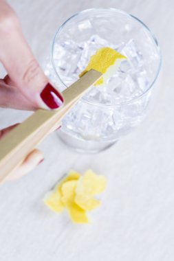 adding a lemon peel to a gin toni clipart