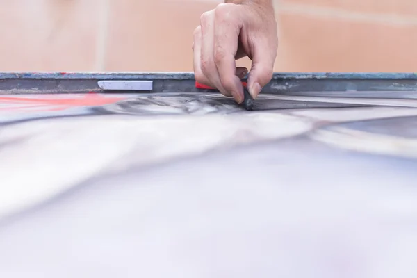 Hand painting a canvas with chalk — Stock Photo, Image