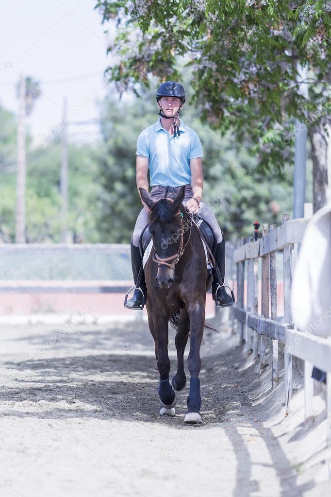 Young man riding a horse