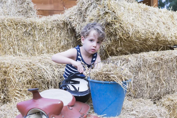 Young rider in the hay bales — Stock Photo, Image