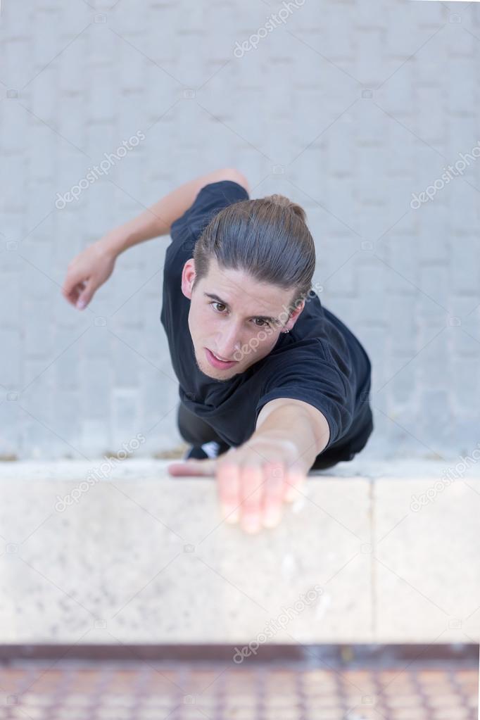 Young athlete climbing on wall