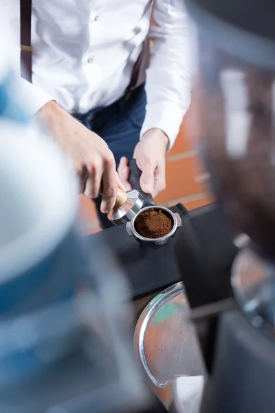 Close-up of man hands with holder pressing coffee — Stock Photo, Image