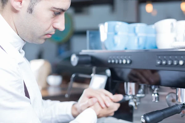 Side view of male bartender making coffee Royalty Free Stock Photos