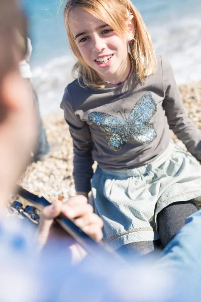 Close-up van blond meisje zingen lied op strand — Stockfoto