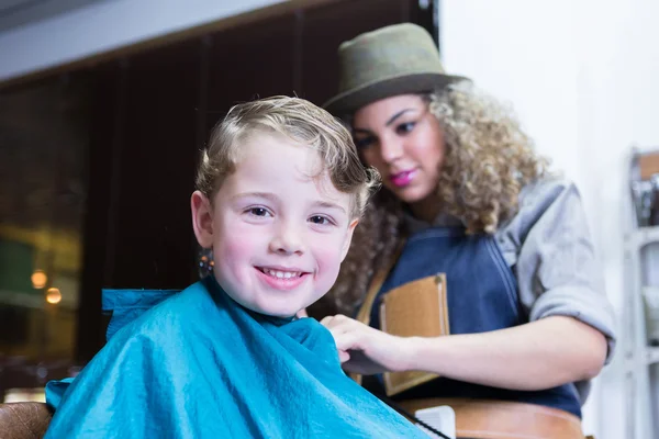 Boy looking at camera in barber shop — Stock Photo, Image