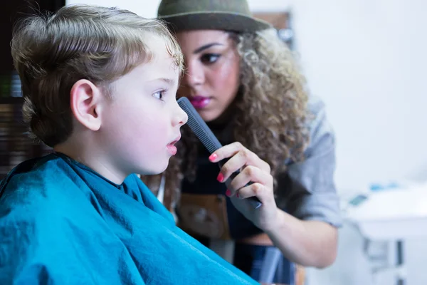 Close-up of young boy sitting in barber chair — Stock Photo, Image