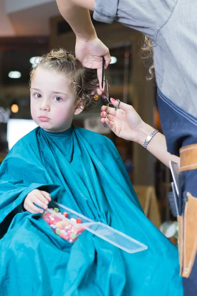 Female hairdresser cutting boy hair — Stock Photo, Image