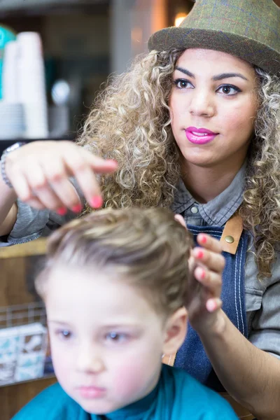 Female hairdresser setting boy hair — Stock Photo, Image