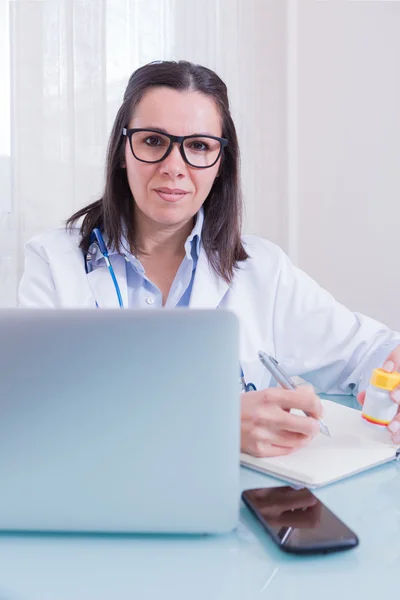 Portrait of female doctor working at table — Stock Photo, Image