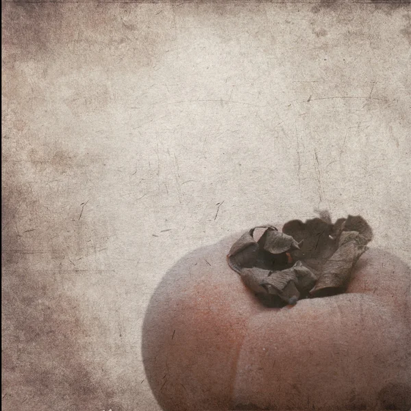 The textured old paper background with apanese persimmon. — Stockfoto