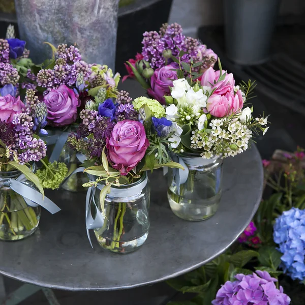 Small bouquets of lilacs, hyacinths, anemones, roses and peonies — Stock Photo, Image