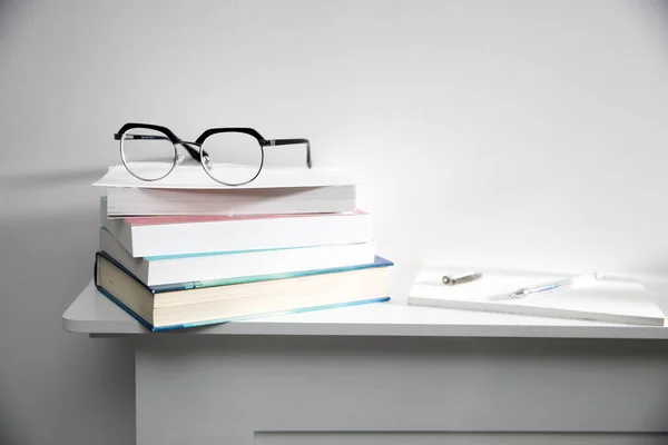 Stack Books Glasses Them White Tabletop Pen Notebook — Stock Photo, Image