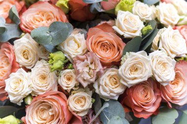 Düğün buketi portakal ve beyaz güller, lisianthus ve okaliptüs. Arkaplan