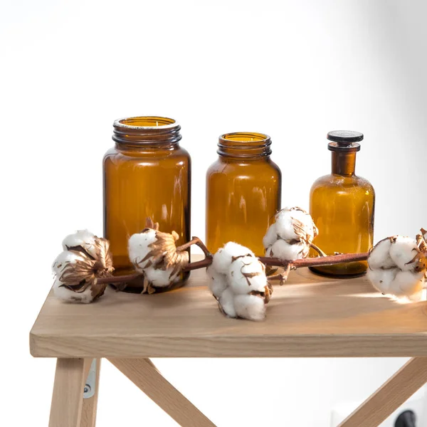 Three Pharmacy Bottles Branch Cotton Flowers Wooden Stool Surface White — Stock Photo, Image