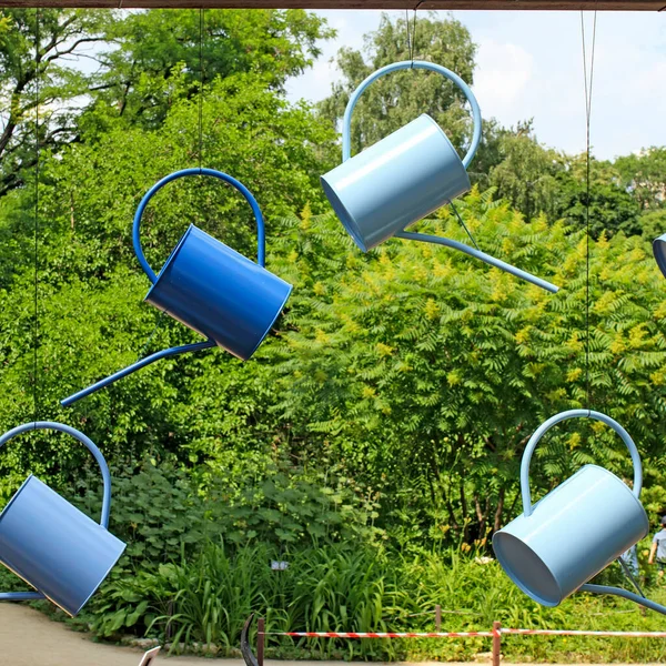 Multi Colored Blue Watering Cans Hang Window Backdrop Green Trees — Stock Photo, Image