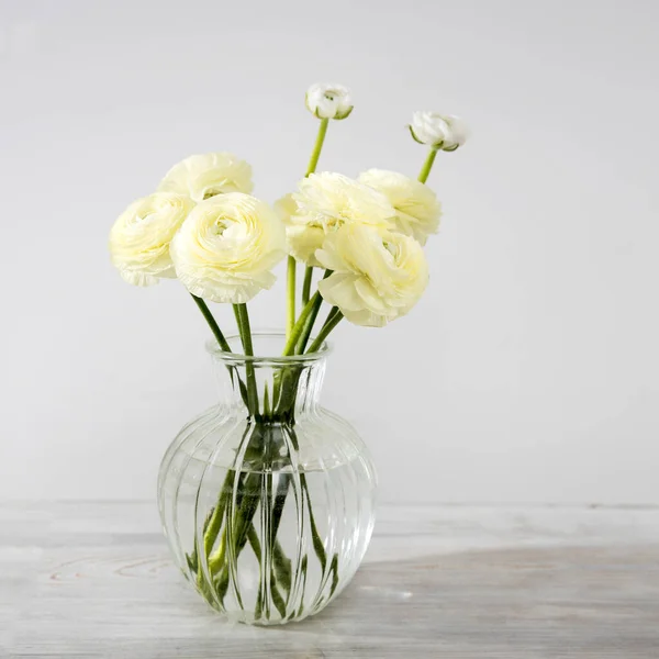 Bouquet Pale Yellow Persian Buttercups Glass Vase Table Grey Wall — Stock fotografie