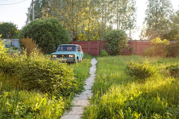 Moscow, Russia - 12 June 2021, Blue car VAZ (Lada) 2014 in the courtyard of a country house