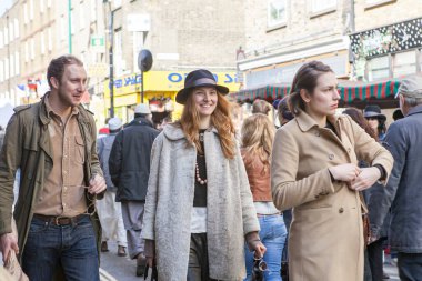 Londra, İngiltere - Kasım 2019, genç adam ve kadın tuğla şeritte kalabalığın arasında yürüyor