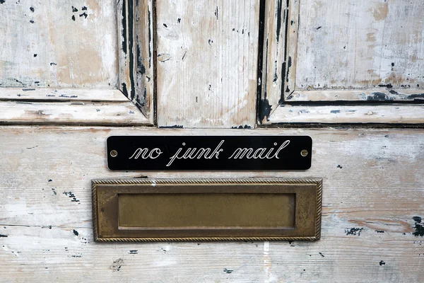 House letterbox with 'No junk mail' sign and junk mail — Stock Photo, Image