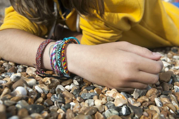 Hand of girl lying on the beach — Stock Photo, Image