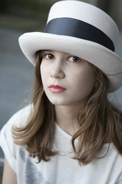 Serious youn girl in tall hat — Stock Photo, Image