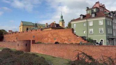 Varşova, Polonya, 8 Ekim 2025. Eski kasaba Castle Square 'de başlıyor. Kraliyet Kalesi ve savunma duvarı bulutlu ve güneşli dramatik bir gökyüzüne karşı duruyor..