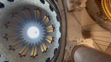 Kudüs, İsrail, 23 Ekim 2025, Kutsal Mezar Kilisesi 'nin yaldızlı kubbesi, Tanrı' nın Tapınağı, fresklerle süslenmiş ve parlayan ışıkla yıkanmış. Kamera yavaşça döner..