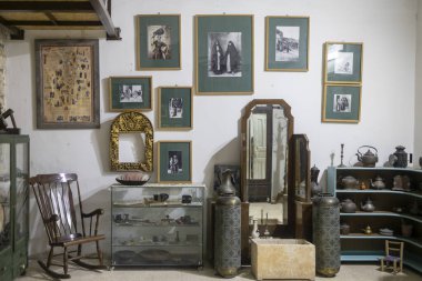 Nasıra, İsrail, 24 Aralık 2025, içinde ahşap sallanan sandalye, vitrinler ve çerçeveli tarihi fotoğraflar bulunan eski bir odanın ya da müzenin içi. El Sebat Derneği ve Nasıra 'daki Miras Müzesi