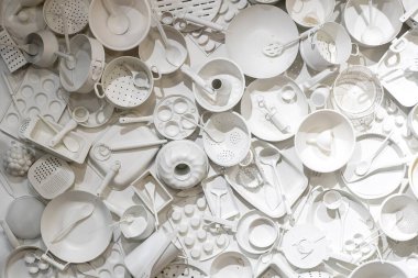 Katı beyaz renge boyanmış çeşitli mutfak gereçleri ve yemek takımlarının üst görünümü.