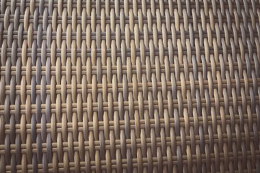 Sentetik rattan dokuma arka planı bahçe mobilyalarında kullanılıyor..