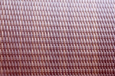 Sentetik rattan dokuma arka planı bahçe mobilyalarında kullanılıyor..