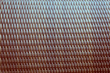 Sentetik rattan dokuma arka planı bahçe mobilyalarında kullanılıyor..